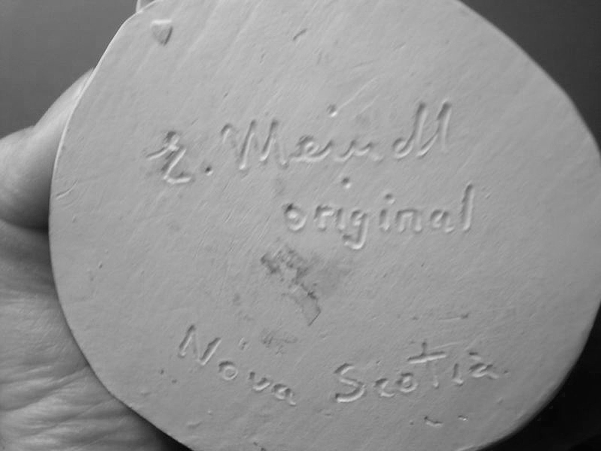 Signature on base of figurinee